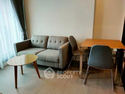 Modern living room with stylish sofa and dining table, perfect for cozy gatherings.