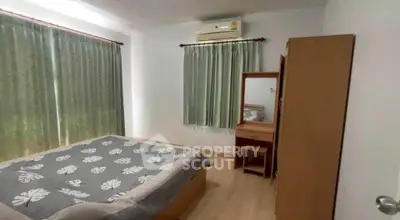 Cozy bedroom with air conditioning and elegant wooden furniture