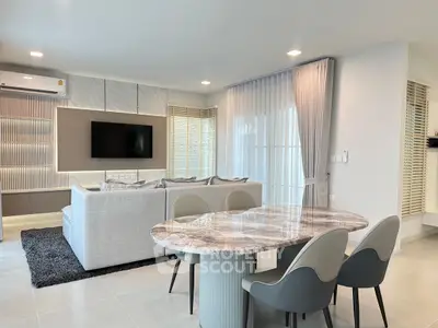 Modern living room with elegant dining area and stylish furniture