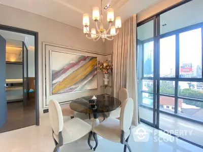 Elegant dining area with modern chandelier and city view balcony