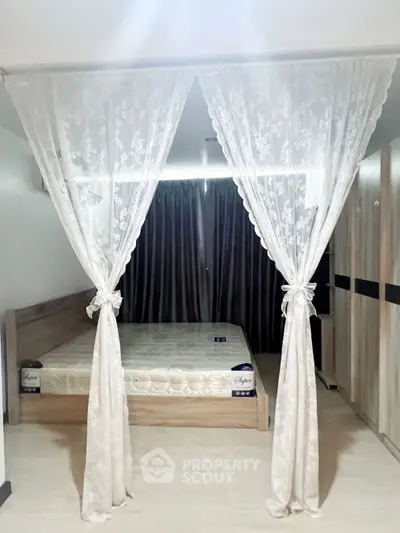 Elegant bedroom with lace curtains and modern wooden furniture