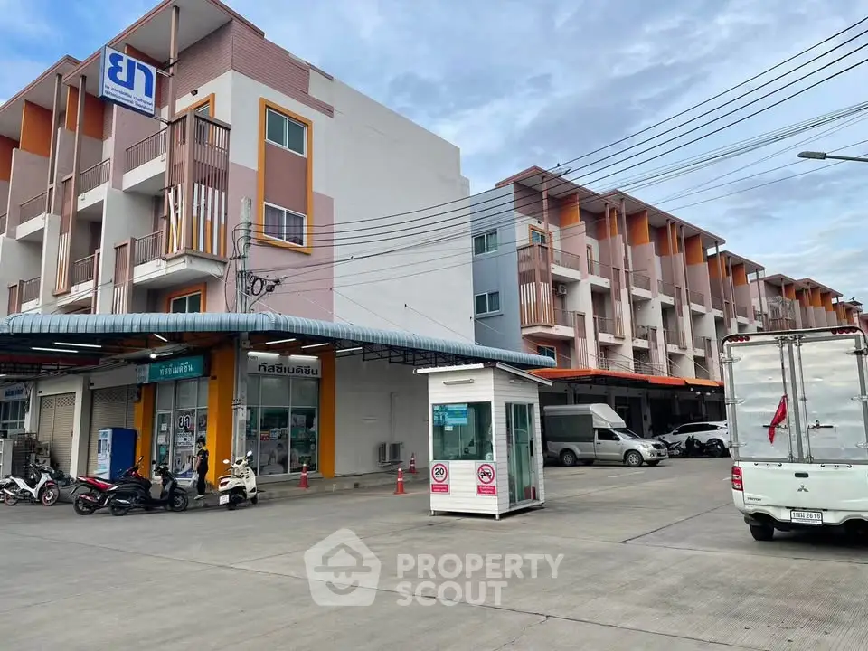 Modern commercial building with parking area and retail shops, ideal for business opportunities.