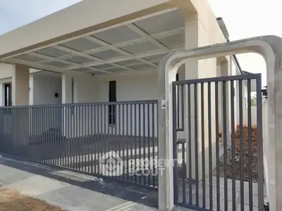 Modern minimalist house exterior with sleek metal gate and covered carport