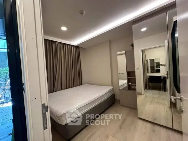 Modern bedroom with mirrored wardrobe and natural light