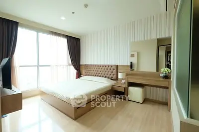Spacious modern bedroom with large window and elegant furnishings