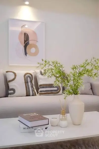 Stylish living room with modern decor, cozy sofa, and elegant coffee table arrangement.