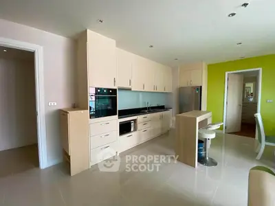 Modern kitchen with sleek cabinetry and built-in appliances in a bright apartment.