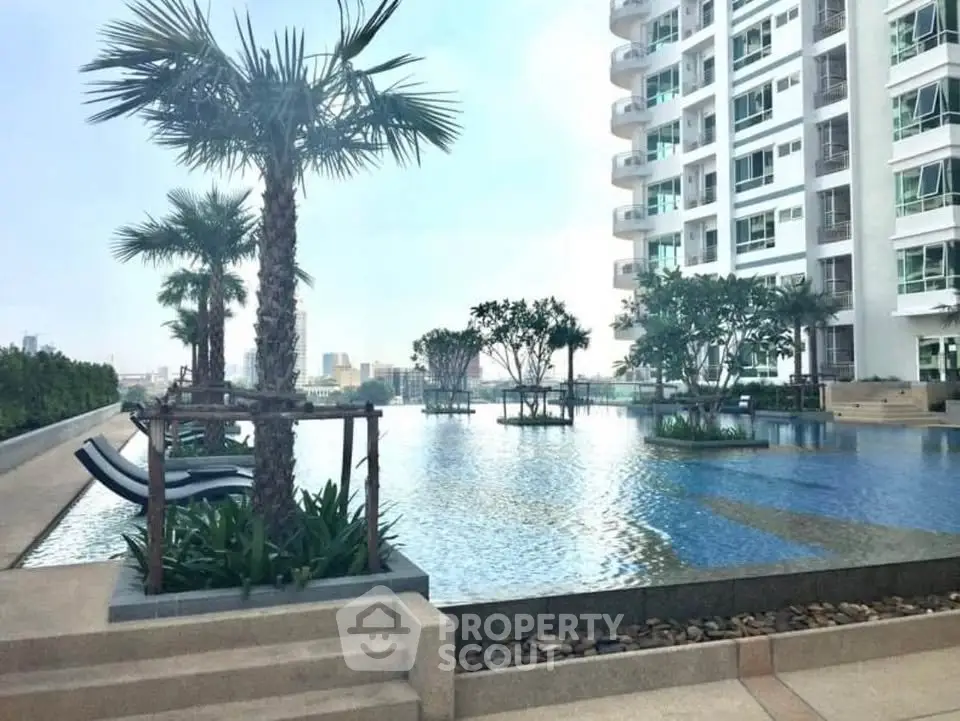 Luxurious condominium with stunning pool and palm trees, offering a serene urban oasis.