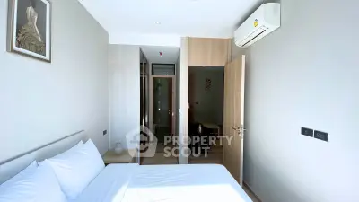 Modern bedroom with air conditioning and minimalist decor in a stylish apartment.