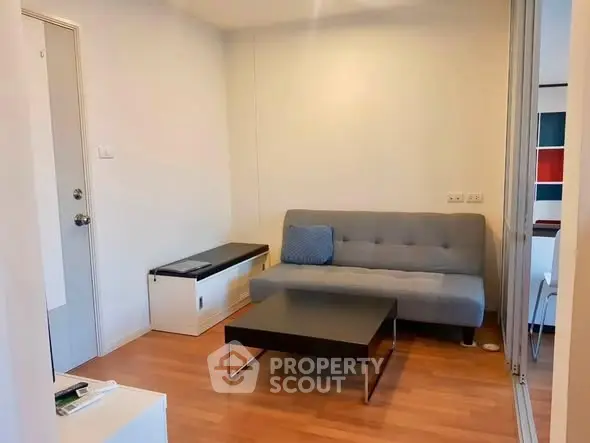 Cozy living room with modern sofa and coffee table, perfect for relaxation.