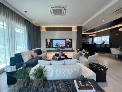 Luxurious modern living room with elegant decor and spacious seating area.
