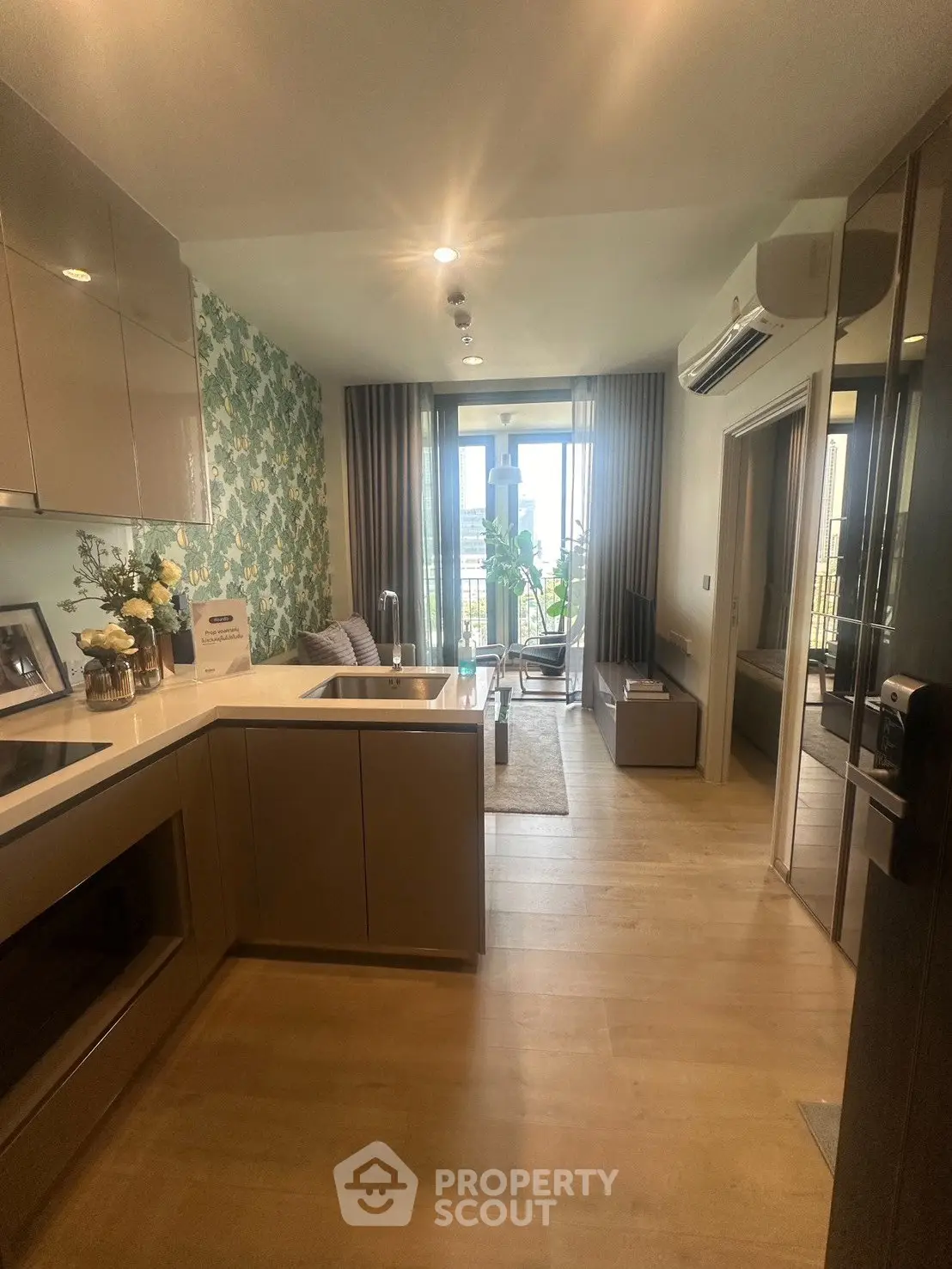 Modern open-layout kitchen and living room with balcony view in stylish apartment