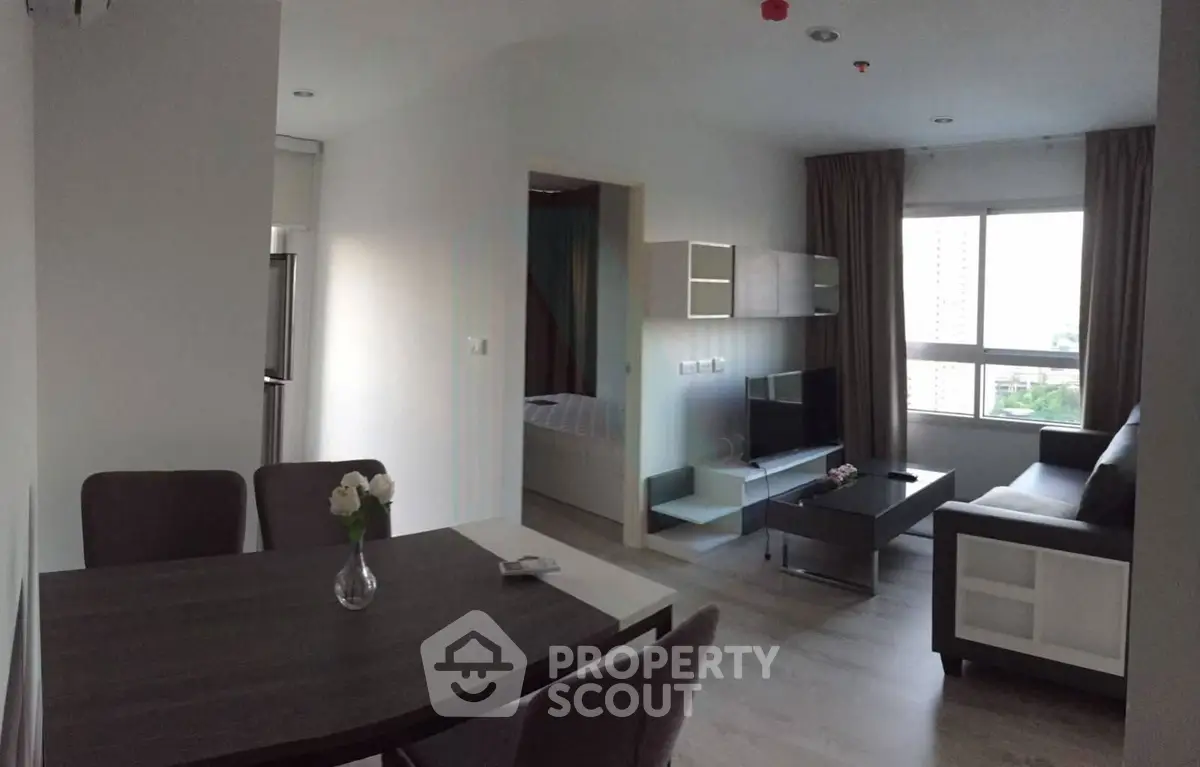 Modern open-plan living room with dining area and large window view