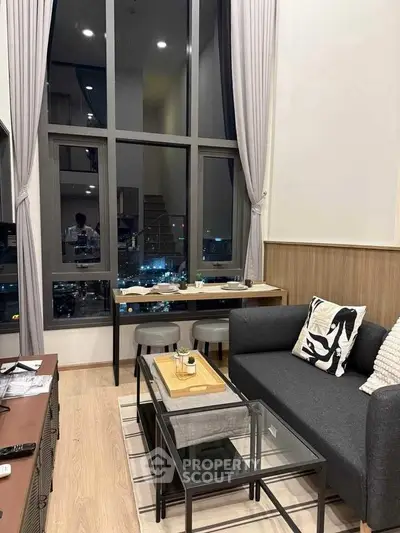 Modern living room with floor-to-ceiling windows and stylish decor