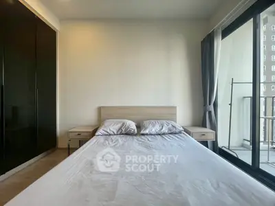 Modern bedroom with balcony access and sleek wardrobe design