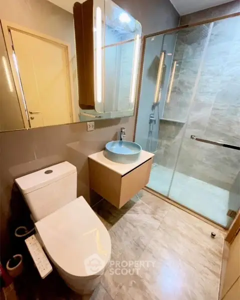Modern bathroom with sleek fixtures and glass shower enclosure