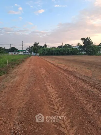 Expansive plot of land with clear skies, ideal for development opportunities.