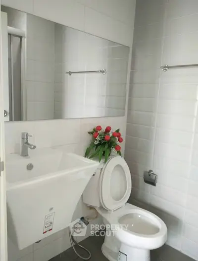 Modern bathroom with sleek white fixtures and elegant tile design