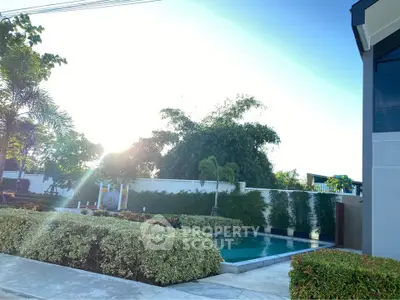 Luxurious outdoor pool area with lush greenery and modern design, perfect for relaxation and leisure.