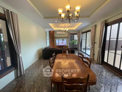 Spacious living room with elegant dining area and large windows for natural light.