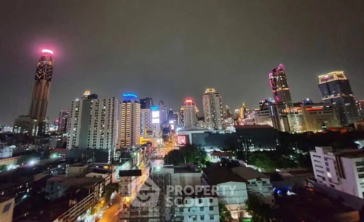Stunning cityscape view of illuminated skyscrapers at night showcasing urban living.