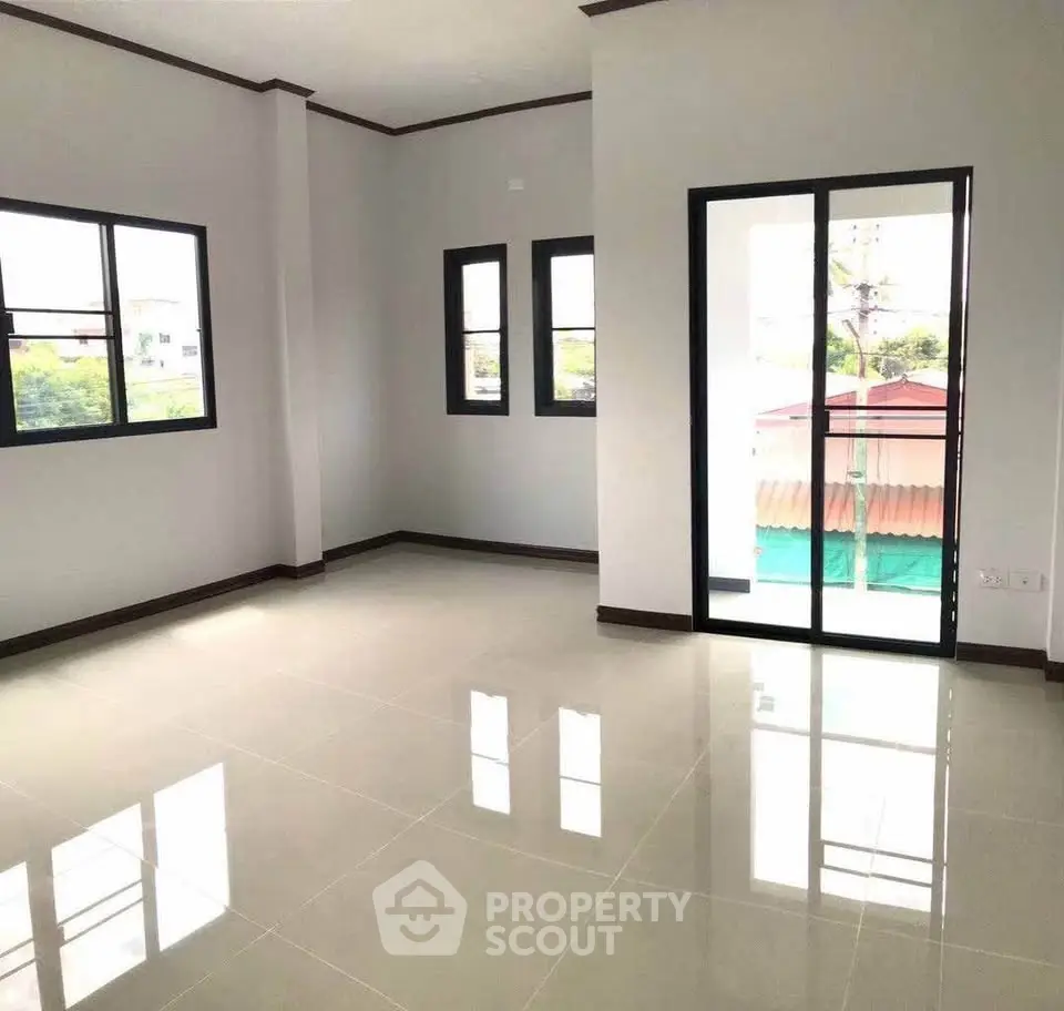 Spacious empty room with large windows and sliding glass door, perfect for customization.