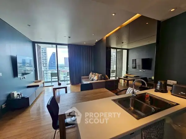 Modern open-layout living room with kitchen and city view balcony in luxury apartment.