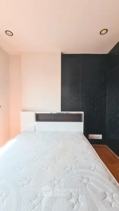 Modern bedroom with stylish black accent wall and cozy lighting