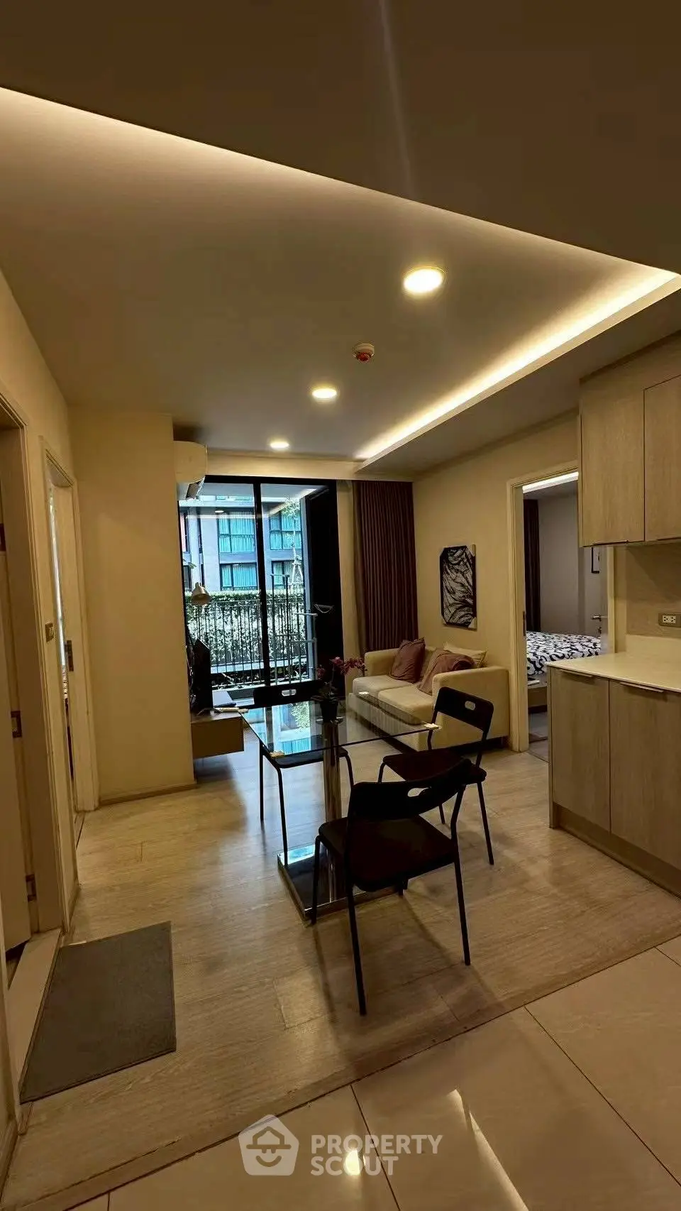 Modern open-layout living room with stylish furniture and balcony view in a contemporary apartment.