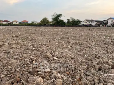 Expansive plot of land ready for development in a serene residential area.