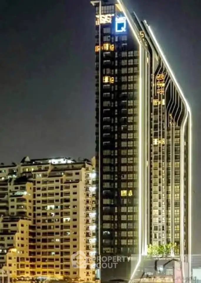 Stunning night view of modern high-rise buildings with illuminated architecture.