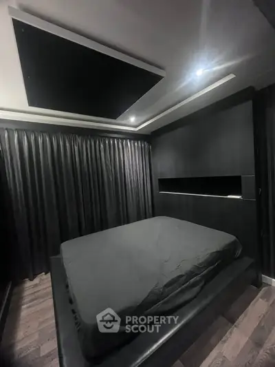 Luxurious modern bedroom with sleek black decor and ambient lighting