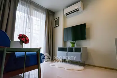 Modern living room with air conditioning, TV, and stylish decor in a bright apartment.