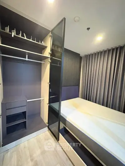 Modern bedroom with built-in wardrobe and sleek design, perfect for urban living.