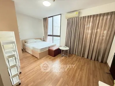 Spacious bedroom with modern decor and natural light