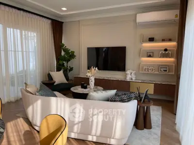 Elegant living room with modern furniture, large windows, and stylish decor for a cozy ambiance.
