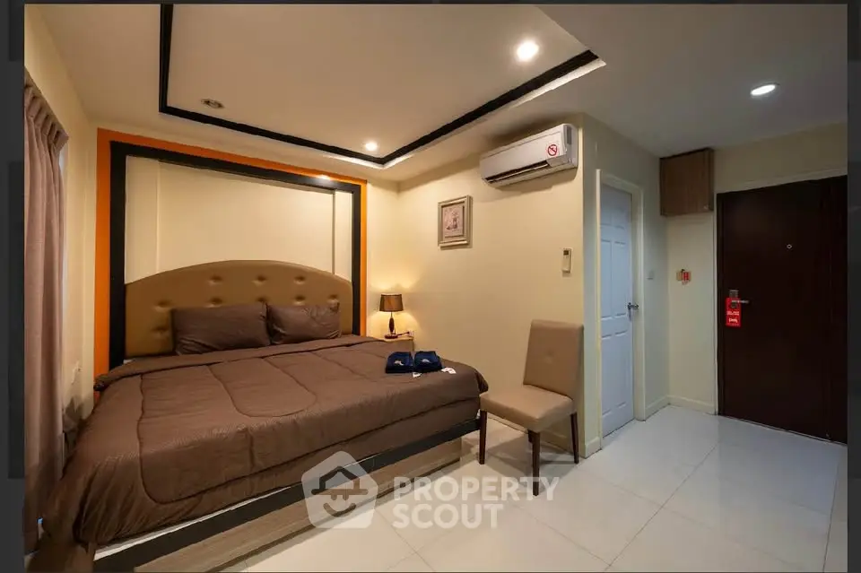 Cozy bedroom with modern decor and air conditioning in a stylish apartment.