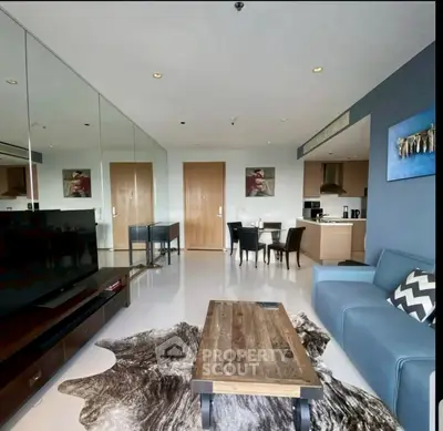 Modern living room with stylish decor, open kitchen, and cozy seating area in a contemporary apartment.