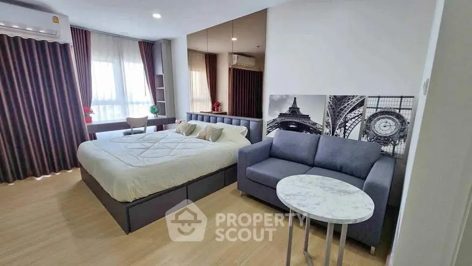Modern studio apartment with cozy bed and stylish sofa in open layout