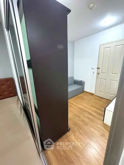 Cozy modern living space with wooden flooring and sleek furniture