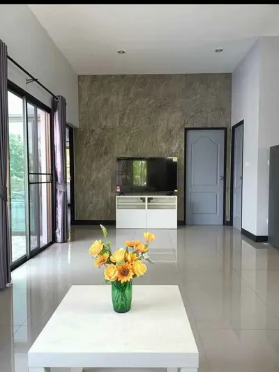 Modern living room with sleek TV stand and vibrant floral centerpiece