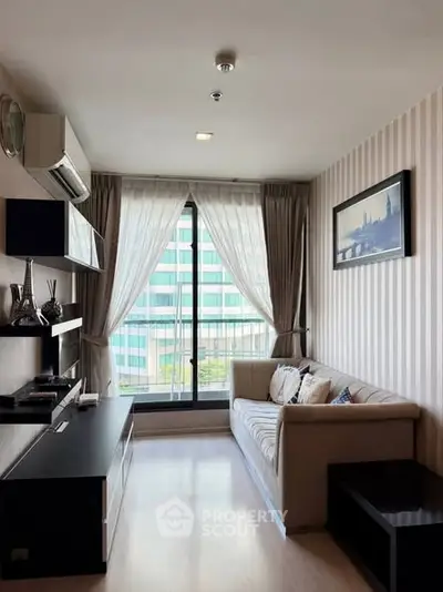 Modern living room with large window and stylish decor in urban apartment.