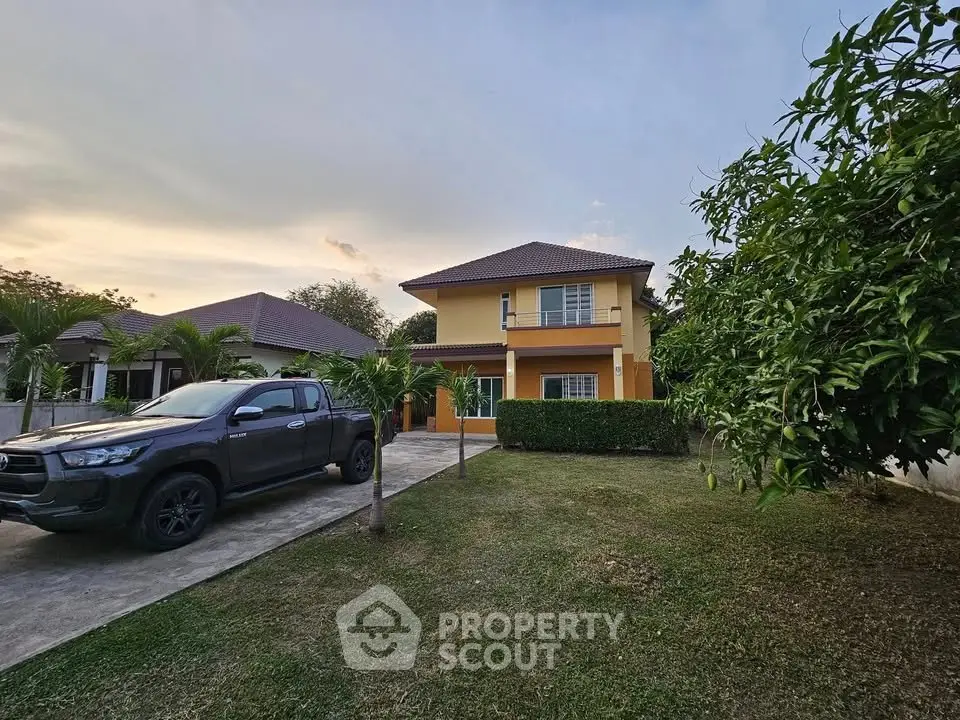 Charming two-story house with spacious garden and driveway in serene neighborhood.