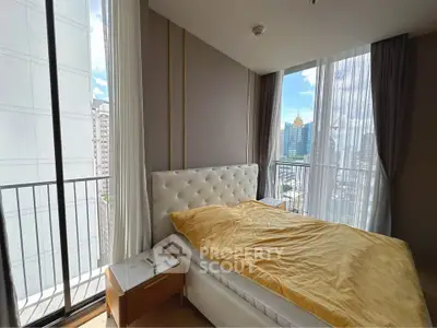 Luxurious bedroom with stunning city view and elegant furnishings.