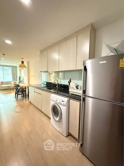 Modern kitchen with sleek appliances and open layout in a stylish apartment