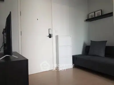 Modern minimalist living room with sleek furniture and wall-mounted shelf.