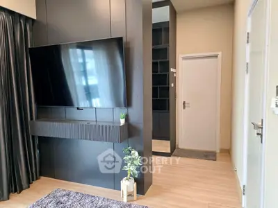 Modern living room with sleek black entertainment center and large TV