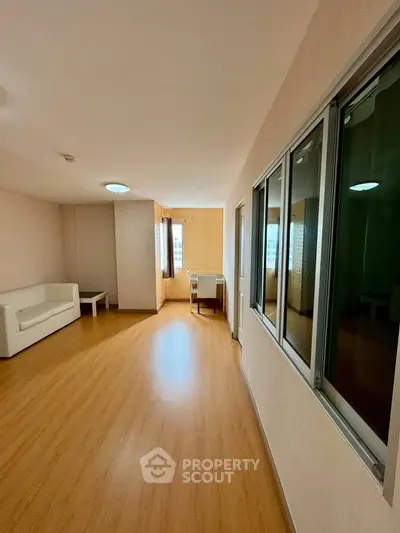 Spacious living room with wooden flooring and modern furniture