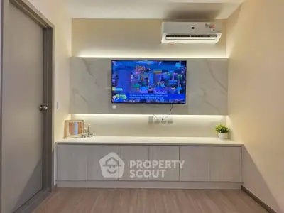 Modern living room with wall-mounted TV and air conditioning unit.
