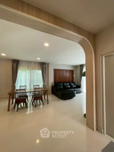 Spacious modern living room with elegant dining area and natural light